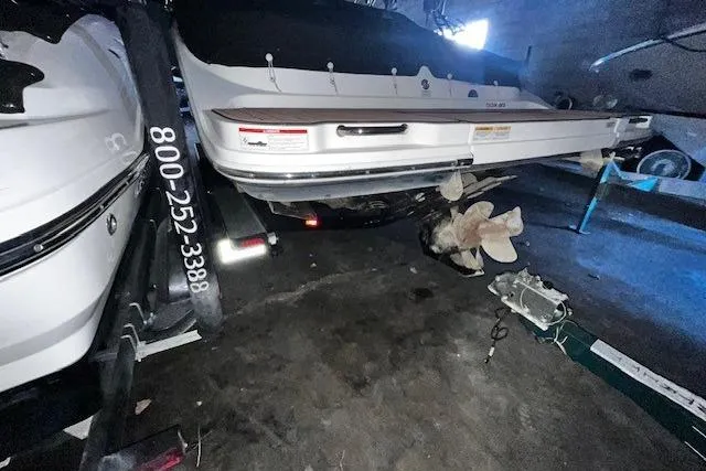 Slide: The Image of 2018 Sea Ray SDX 270 boat on trailer in dimly lit storage area. - 27