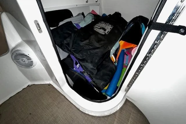 Slide: The Image of Storage compartment in 2018 Sea Ray SDX 270 boat with life jackets and gear. - 32