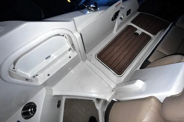 Slide: The Image of 2018 Sea Ray SDX 270 boat interior with storage compartment and seating area. - 33