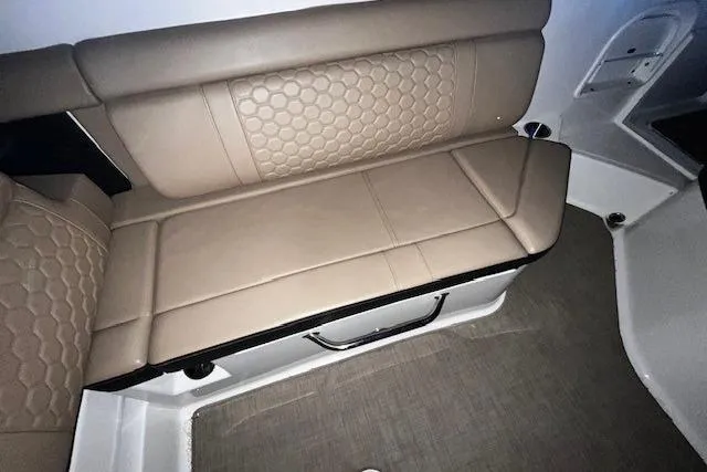 Slide: The Image of 2018 Sea Ray SDX 270 boat interior with beige cushioned seating and hexagonal pattern. - 37
