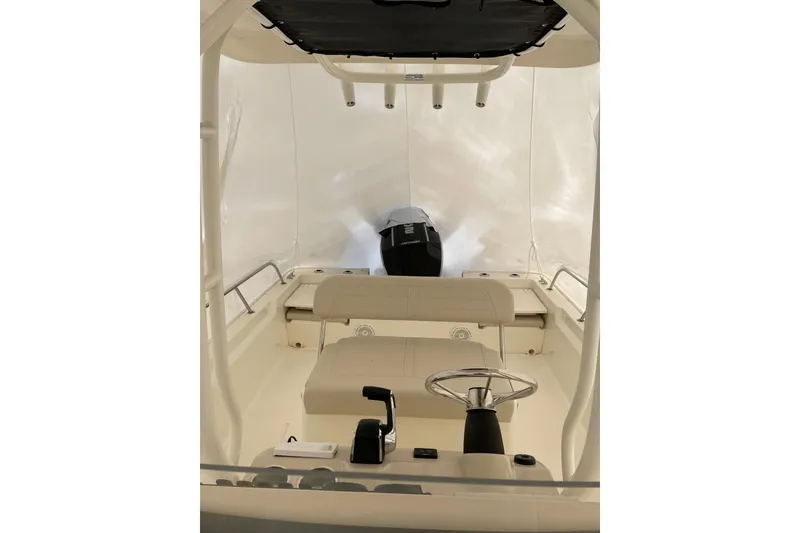 Slide: The Image of 2025 Boston Whaler 210 Montauk boat interior with steering wheel and seating. - 2
