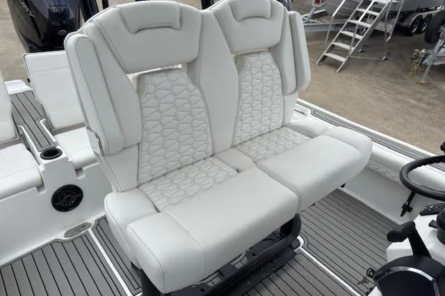 Slide: The Image of 2026 Tidewater 2500 Carolina Bay boat with luxurious white seating and modern design. - 11