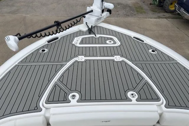 Slide: The Image of 2026 Tidewater 2500 Carolina Bay boat deck with gray non-slip surface and trolling motor. - 15