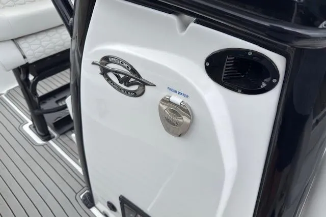 Slide: The Image of 2026 Tidewater 2500 Carolina Bay boat interior with fresh water access and seating. - 21
