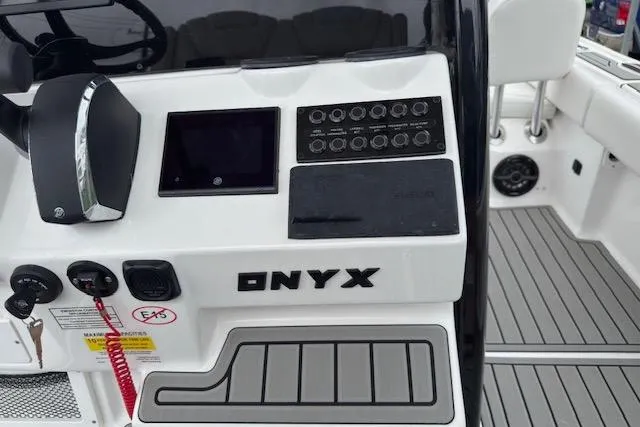 Slide: The Image of Control panel of 2026 Tidewater 2500 Carolina Bay boat with "ONYX" branding. - 22