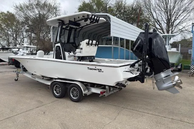 Slide: The Image of 2026 Tidewater 2500 Carolina Bay boat on trailer, featuring sleek design and powerful outboard motor. - 3