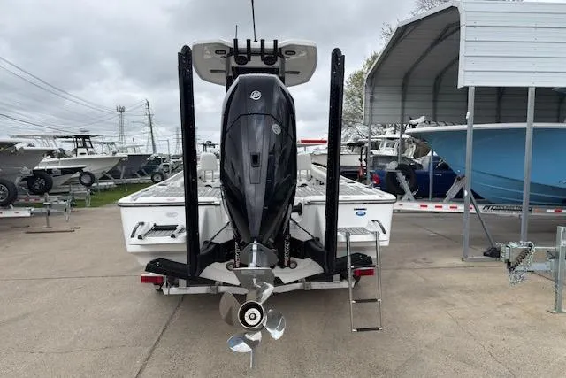 Slide: The Image of 2026 Tidewater 2500 Carolina Bay boat with powerful outboard motor, parked at a marina. - 4