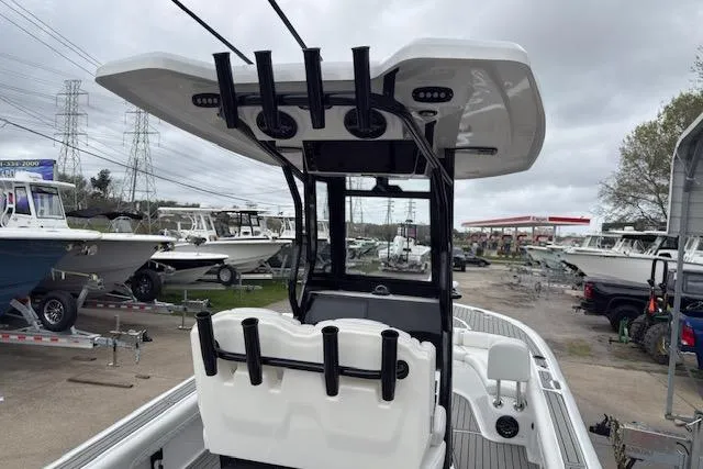 Slide: The Image of 2026 Tidewater 2500 Carolina Bay boat with T-top and rod holders in a marina. - 7