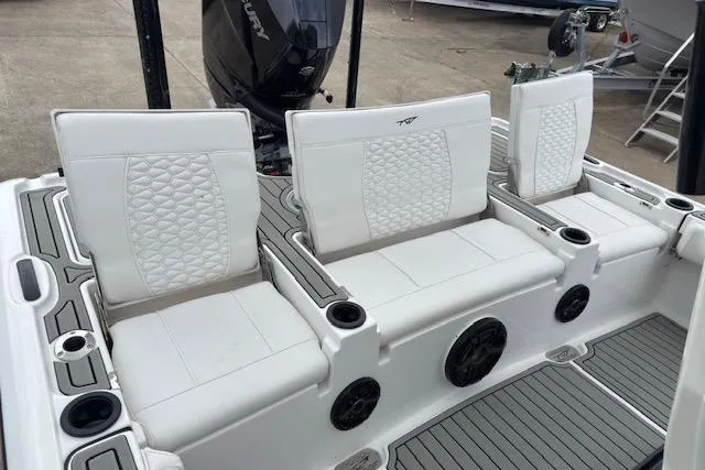 Slide: The Image of 2026 Tidewater 2500 Carolina Bay boat with white cushioned seating and cup holders. - 9