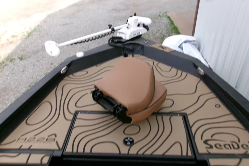 Slide: The Image of 2026 Xpress H22B Bay boat with patterned deck and tan seat. - 12