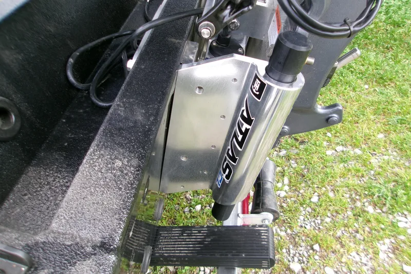 Slide: The Image of 2026 Xpress H22B Bay boat with Atlas hydraulic jack plate on grassy surface. - 15