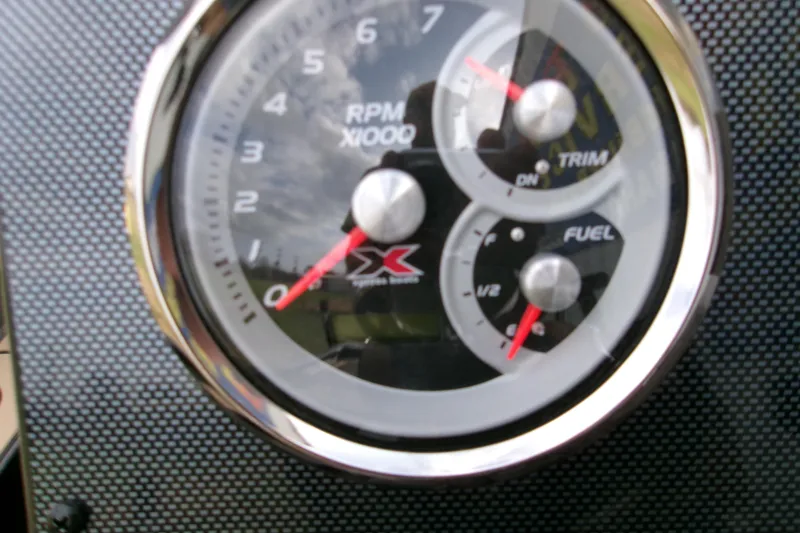 Slide: The Image of Close-up of 2026 Xpress H22B Bay boat dashboard gauges, showing RPM, trim, and fuel levels. - 19