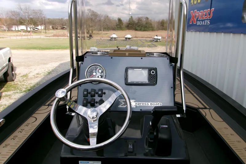 Slide: The Image of 2026 Xpress H22B Bay boat dashboard with steering wheel and navigation system. - 21