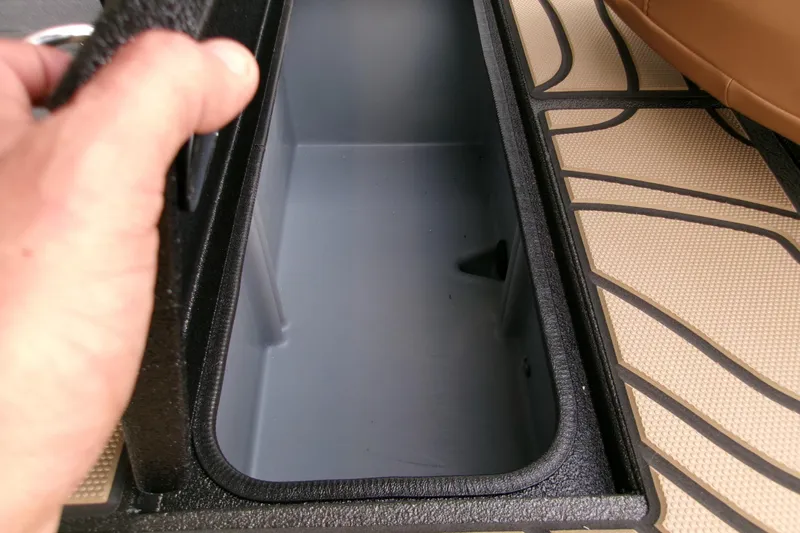 Slide: The Image of Open storage compartment in 2026 Xpress H22B Bay boat, featuring textured flooring. - 24