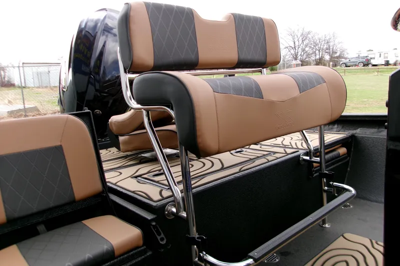 Slide: The Image of 2026 Xpress H22B Bay boat interior with stylish brown and black seating. - 5