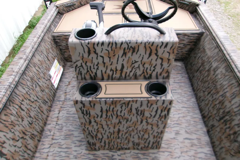 Slide: The Image of 2026 Xpress Bayou 180CC boat interior with camouflage design and steering console. - 13