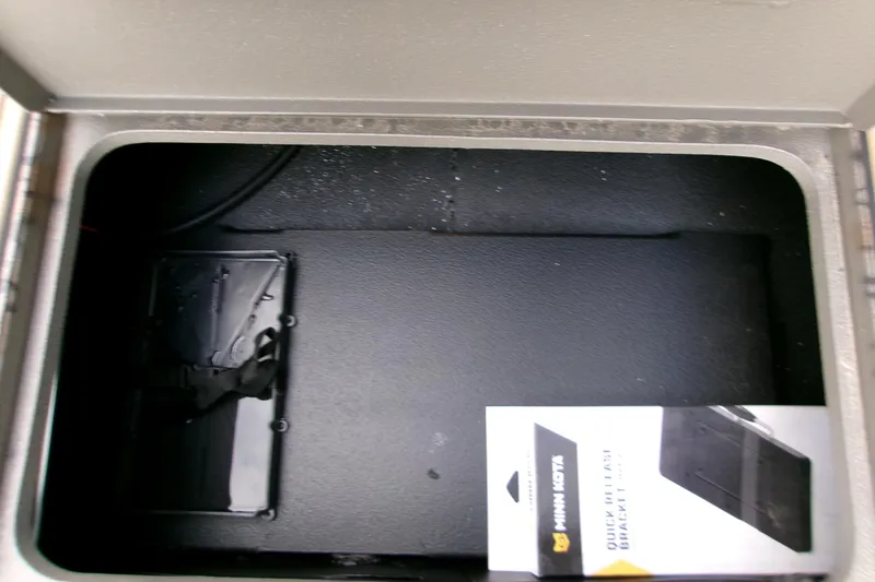 Slide: The Image of Storage compartment of 2026 Xpress Bayou 180CC with Minn Kota quick-release bracket. - 16