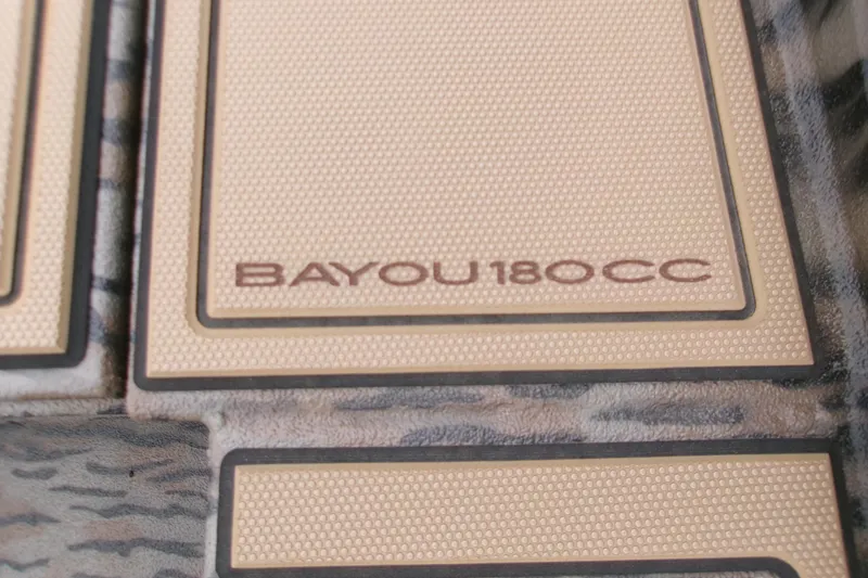 Slide: The Image of 2026 Xpress Bayou 180CC boat flooring with textured design and logo. - 17