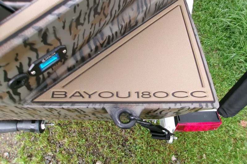 Slide: The Image of 2026 Xpress Bayou 180CC boat detail with camouflage design on grass. - 19
