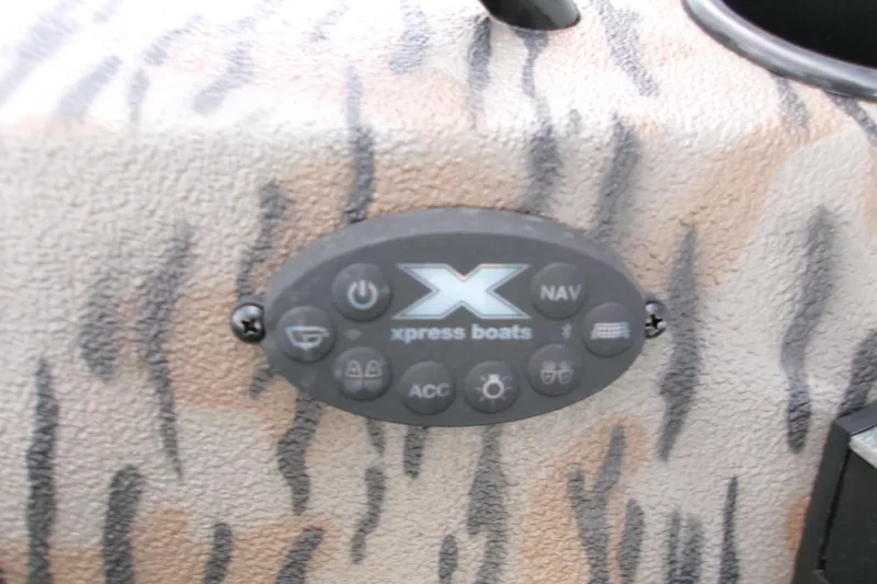 Slide: The Image of Control panel of 2026 Xpress Bayou 180CC boat with camouflage design. - 21