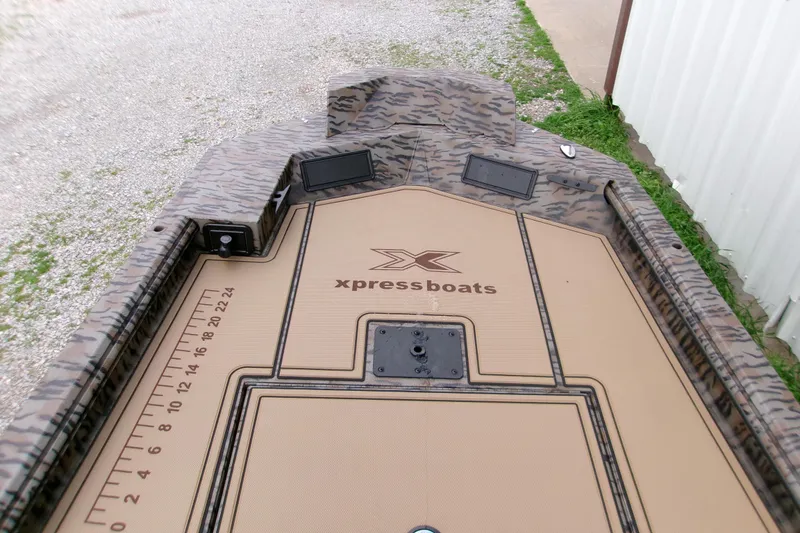 Slide: The Image of 2026 Xpress Bayou 180CC boat deck with camouflage design and measurement markings. - 22