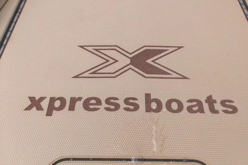 Slide: The Image of 2026 Xpress Bayou 180CC boat logo on textured surface. - 23