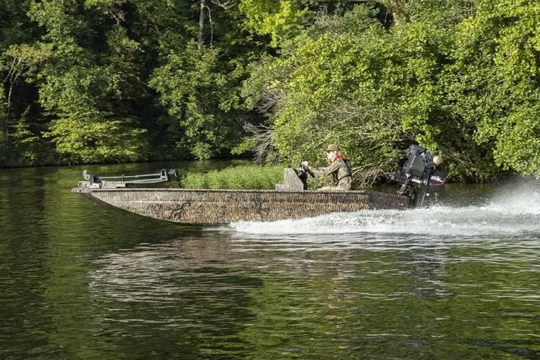 Slide: The Image of Manufacturer Provided Image: 2026 Xpress Bayou 180CC boat cruising on a lush, green river. - 3