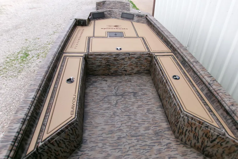 Slide: The Image of 2026 Xpress Bayou 180CC boat interior with camouflage design and storage compartments. - 5