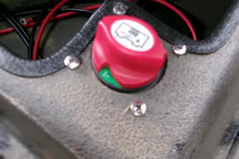 Slide: The Image of Red battery switch on 2026 Xpress Bayou 180CC boat with visible wiring. - 7