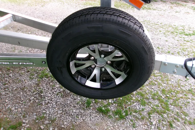 Slide: The Image of Trailer wheel of 2026 Xpress Bayou 180CC on gravel surface. - 9