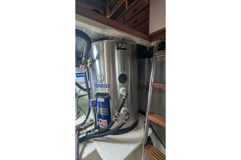 Slide: The Image of Torrid water heater in 2005 Kadey-Krogen Pilothouse engine room with ladder access. - 102