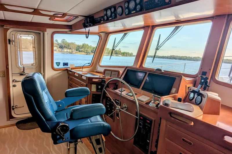 Slide: The Image of Pilothouse interior of 2005 Kadey-Krogen, featuring navigation equipment and scenic water view. - 105