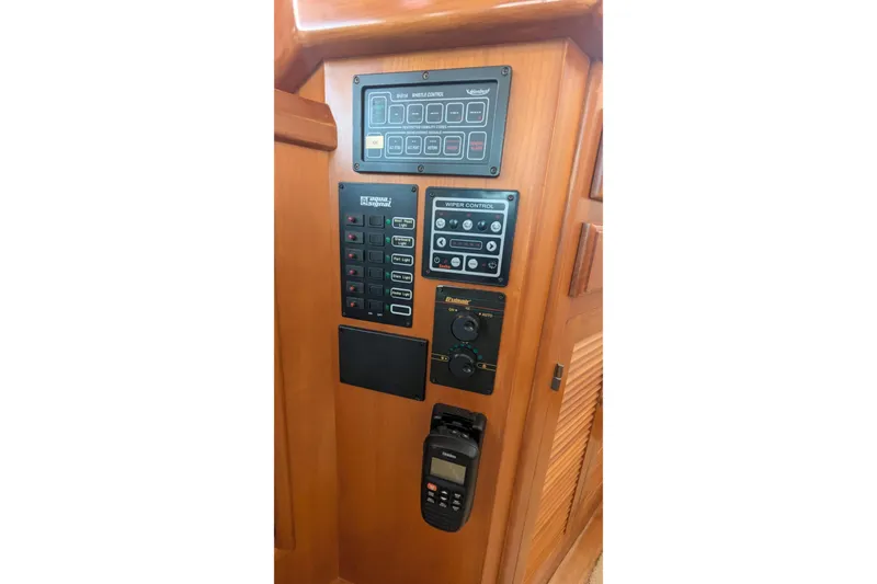 Slide: The Image of Control panel of a 2005 Kadey-Krogen Pilothouse with various switches and displays. - 109