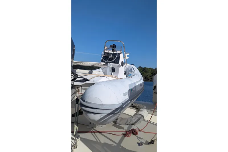 Slide: The Image of 2005 Kadey-Krogen Pilothouse with inflatable boat on deck, clear blue sky background. - 11