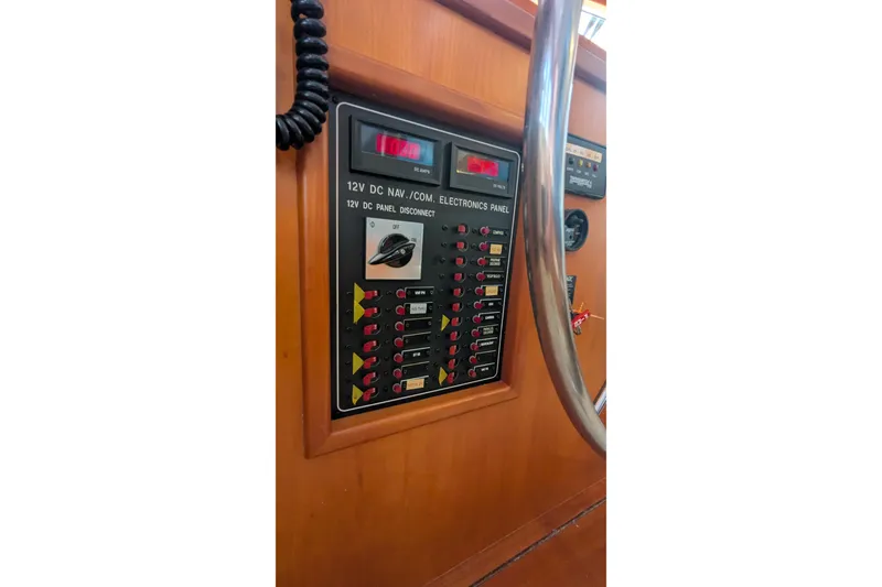 Slide: The Image of 2005 Kadey-Krogen Pilothouse electronics panel with 12V DC navigation controls. - 111