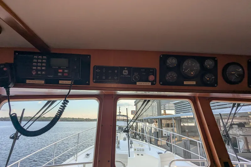 Slide: The Image of 2005 Kadey-Krogen Pilothouse interior with navigation instruments and water view. - 115