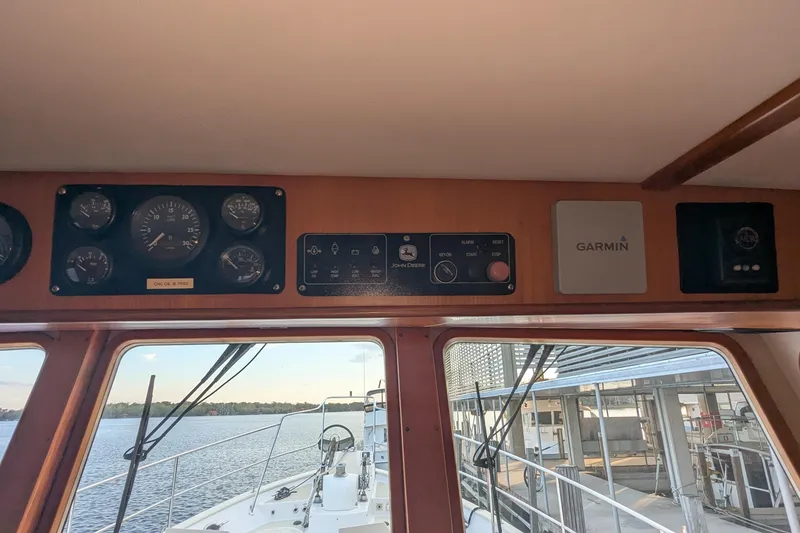 Slide: The Image of 2005 Kadey-Krogen Pilothouse interior with navigation instruments and Garmin equipment. - 116