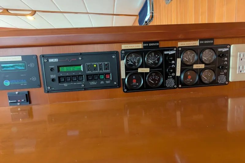 Slide: The Image of Control panel of a 2005 Kadey-Krogen Pilothouse with generator and inverter displays. - 118