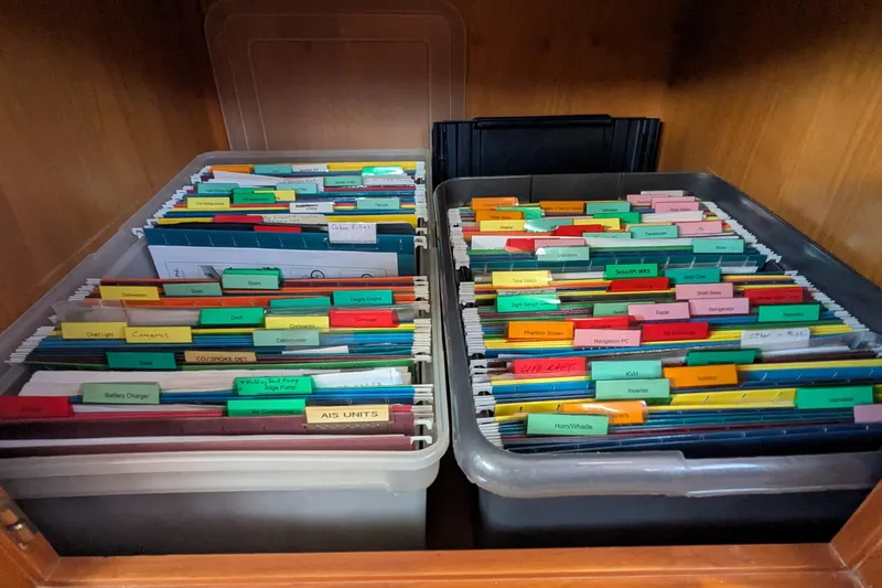 Slide: The Image of Organized file folders in a Kadey-Krogen Pilothouse, 2005 model, neatly stored in bins. - 119