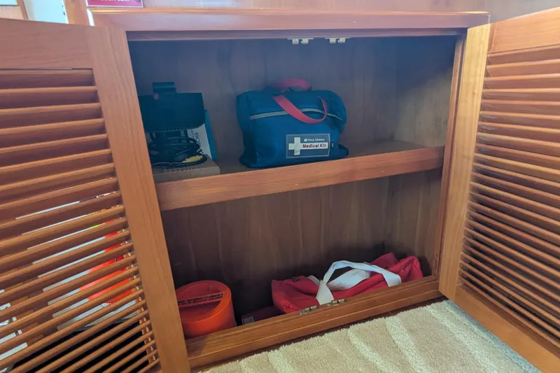 Slide: The Image of Open wooden cabinet on 2005 Kadey-Krogen Pilothouse, storing medical kit and equipment. - 120