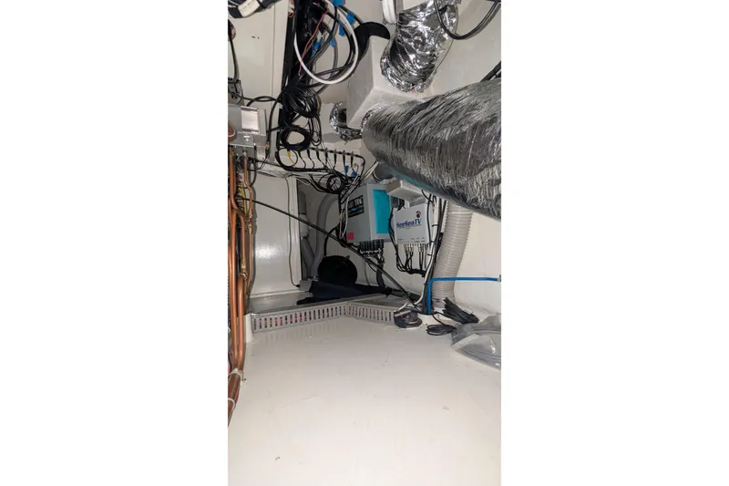 Slide: The Image of 2005 Kadey-Krogen Pilothouse engine room with wiring and equipment. - 123