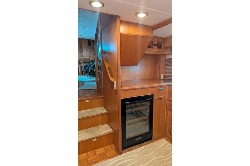 Slide: The Image of 2005 Kadey-Krogen Pilothouse interior with wooden stairs and built-in wine cooler. - 126