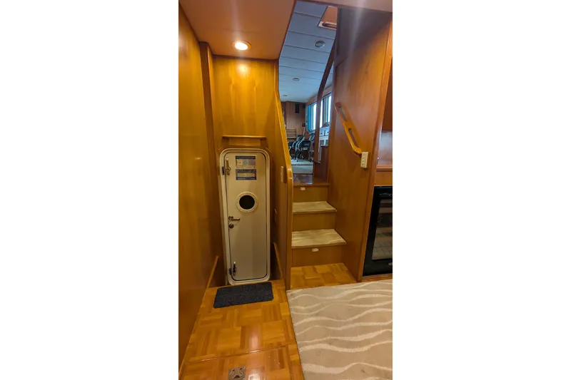 Slide: The Image of Interior of 2005 Kadey-Krogen Pilothouse with wooden stairs and nautical door. - 130