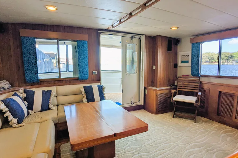 Slide: The Image of Luxurious 2005 Kadey-Krogen Pilothouse interior with cozy seating and scenic water views. - 132