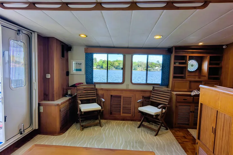 Slide: The Image of Interior of 2005 Kadey-Krogen Pilothouse with wooden decor and lake view through windows. - 135