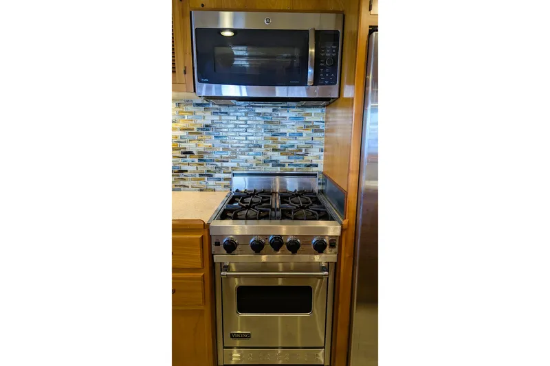 Slide: The Image of Modern kitchen in 2005 Kadey-Krogen Pilothouse with stainless steel stove and microwave. - 139