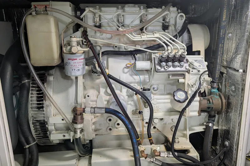 Slide: The Image of Engine of a 2005 Kadey-Krogen Pilothouse, showcasing fuel filter and mechanical components. - 143
