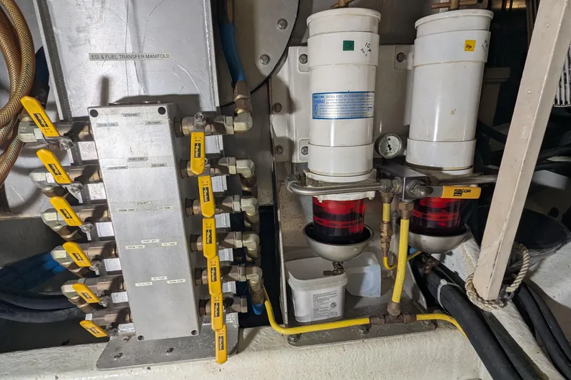 Slide: The Image of Engine room of 2005 Kadey-Krogen Pilothouse with fuel transfer manifold and filters. - 144