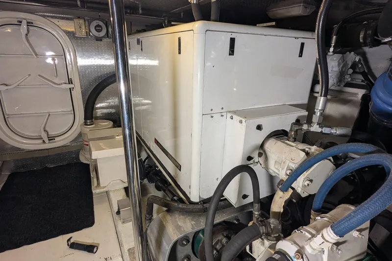 Slide: The Image of Engine room of a 2005 Kadey-Krogen Pilothouse with machinery and equipment. - 153