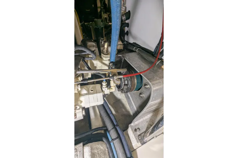 Slide: The Image of Engine compartment of a 2005 Kadey-Krogen Pilothouse with visible hoses and components. - 155